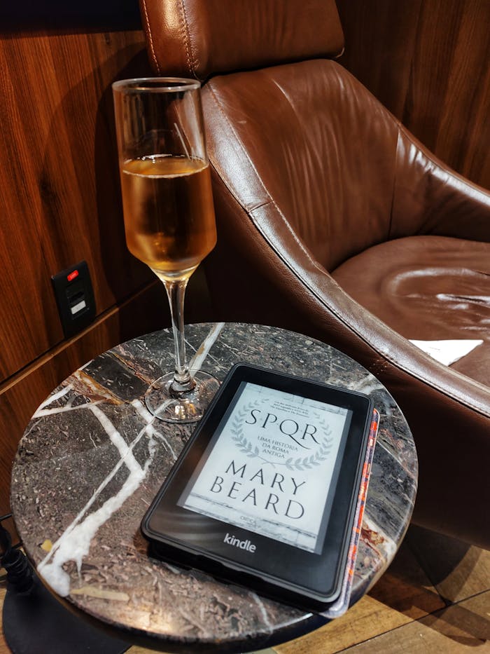 services-cta Luxurious setting with a Kindle e-reader and a glass of champagne on a marble side table.